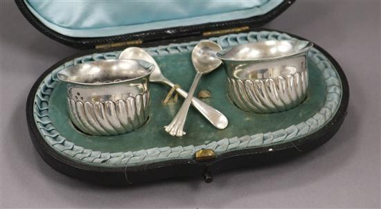 A cased pair of Victorian silver salts and spoons.